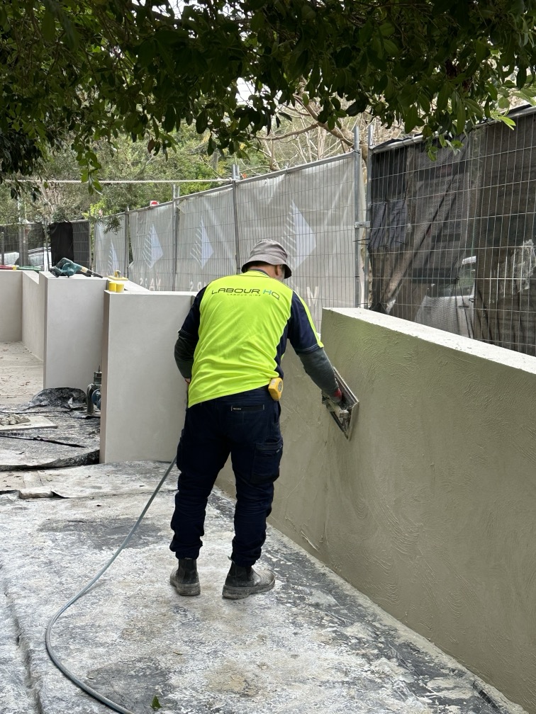 Worker is standing and decorating a concrete surface