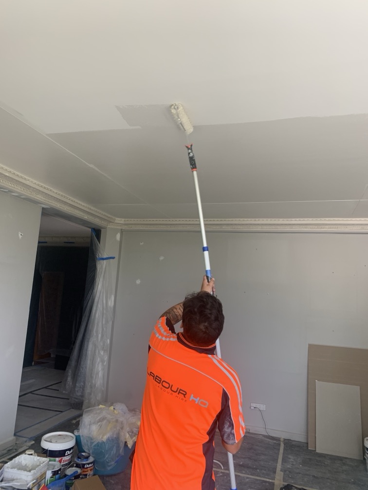 Worker paints a room