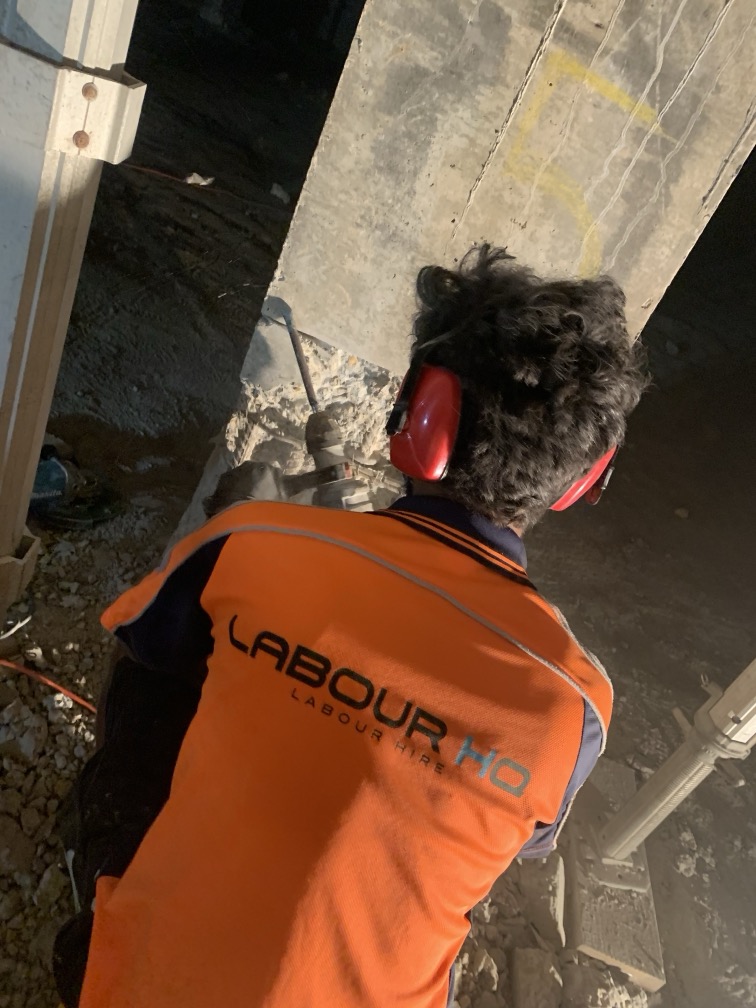 Worker using a tool for the demolition of a wall